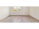 Bedroom with neutral walls, wood-look floors, window and bright natural light at 2107 W Lane Ave, Phoenix, AZ 85021