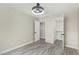 Bright bedroom showcasing wood-look floors, ceiling light fixture, and a walk-in closet with doors at 2107 W Lane Ave, Phoenix, AZ 85021