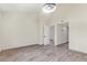Bedroom with neutral walls, modern light fixture, wood-look floors, and bright doorway at 2107 W Lane Ave, Phoenix, AZ 85021