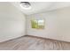 Bedroom with neutral walls, modern light fixture, wood-look floors, and large window at 2107 W Lane Ave, Phoenix, AZ 85021