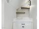 Butler's pantry features bright lighting, floating wood shelves, quartz countertops, and dark hardware at 2107 W Lane Ave, Phoenix, AZ 85021