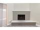 Living room brick fireplace with raised hearth, neutral colors and contemporary design at 2107 W Lane Ave, Phoenix, AZ 85021