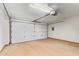 This is a spacious garage with a white door and light colored sealed concrete floors at 2107 W Lane Ave, Phoenix, AZ 85021