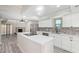 Bright, remodeled kitchen featuring white cabinets, stainless steel appliances, and large island with modern countertops at 2107 W Lane Ave, Phoenix, AZ 85021