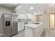 Updated kitchen featuring white cabinetry, stainless appliances, and quartz countertops with a tiled backsplash at 2107 W Lane Ave, Phoenix, AZ 85021