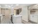 Bright, open kitchen featuring white cabinets, quartz countertops and stainless steel appliances, flowing into the living space at 2107 W Lane Ave, Phoenix, AZ 85021