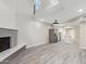 Open concept living room with brick fireplace and mantle, recessed lighting, light wood flooring and large windows at 2107 W Lane Ave, Phoenix, AZ 85021