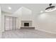 Open-concept living room with a brick fireplace, large windows, and modern flooring with high ceilings at 2107 W Lane Ave, Phoenix, AZ 85021