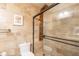 The bathroom offers a toilet and an upgraded shower with body jets and a glass enclosure at 21311 N Shelby Ct, Maricopa, AZ 85138
