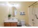 Bright bathroom with a vanity sink, mirror, toilet, and shower-tub combination, ensuring convenience and functionality at 21311 N Shelby Ct, Maricopa, AZ 85138