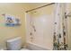 Bathroom featuring a toilet, shower-tub combination, and towel rack, providing essential amenities in a compact space at 21311 N Shelby Ct, Maricopa, AZ 85138