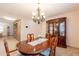 Charming dining room features an elegant chandelier, wood table and chairs, and a built-in china cabinet at 21311 N Shelby Ct, Maricopa, AZ 85138