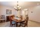 Elegant dining room with chandelier, dining table, and views into the adjacent rooms at 21311 N Shelby Ct, Maricopa, AZ 85138