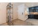 Warm entryway with tile flooring leading to an updated kitchen and a stylish display shelf with decorative vases at 21311 N Shelby Ct, Maricopa, AZ 85138