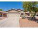 Inviting front exterior showcasing desert landscaping and a well-maintained facade with a two-car garage at 21311 N Shelby Ct, Maricopa, AZ 85138