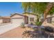 Charming single-story home featuring low-maintenance desert landscaping and an attached two-car garage at 21311 N Shelby Ct, Maricopa, AZ 85138