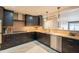 Modern kitchen with dark cabinets, stainless steel appliances and granite countertops at 21311 N Shelby Ct, Maricopa, AZ 85138
