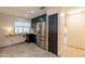 Well-lit kitchen area with stainless steel refrigerator and convenient access to the hallway at 21311 N Shelby Ct, Maricopa, AZ 85138