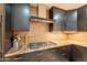 Kitchen with stainless steel vent hood, gas cooktop and granite countertops at 21311 N Shelby Ct, Maricopa, AZ 85138