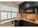 Kitchen with window and granite countertops, offering natural light and food prep space at 21311 N Shelby Ct, Maricopa, AZ 85138