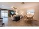 Open-concept living room with tile flooring, ceiling fan, and sliding glass doors leading to the outdoor patio at 21311 N Shelby Ct, Maricopa, AZ 85138