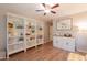 Inviting living room featuring built-in shelves, and wood flooring, offering a cozy and stylish space at 21311 N Shelby Ct, Maricopa, AZ 85138