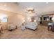Spacious living room with neutral paint, tile flooring, and a comfortable seating area, perfect for relaxation at 21311 N Shelby Ct, Maricopa, AZ 85138