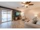 The living room showcases tiled floors, natural light and provides access to the backyard pool at 21311 N Shelby Ct, Maricopa, AZ 85138