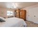 Beautiful main bedroom with wood floors, bright windows, and elegant furniture, offering a serene retreat at 21311 N Shelby Ct, Maricopa, AZ 85138