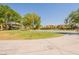 Community park with playground, basketball court, and lush green space for recreation at 21311 N Shelby Ct, Maricopa, AZ 85138