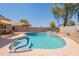 Gorgeous backyard pool with sunshade, blue water, and ample space for lounging at 21311 N Shelby Ct, Maricopa, AZ 85138