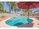 The backyard oasis offers a sparkling pool with a waterfall feature, ideal for summer relaxation and fun at 21311 N Shelby Ct, Maricopa, AZ 85138