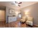 Comfortable sitting area with wood flooring, ceiling fan, natural light, and additional storage space at 21311 N Shelby Ct, Maricopa, AZ 85138