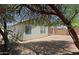 Charming backyard with mature trees, offering shade and privacy with stone details near the building at 2333 W Alta Vista Rd, Phoenix, AZ 85041
