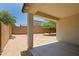 This backyard features a covered patio, block fence, and desert landscaping at 2333 W Alta Vista Rd, Phoenix, AZ 85041