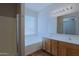 This bathroom features a tub, shower, dual sinks, and vanity lights at 2333 W Alta Vista Rd, Phoenix, AZ 85041