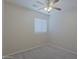 Clean bedroom with neutral walls and carpet, with ceiling fan and window at 2333 W Alta Vista Rd, Phoenix, AZ 85041