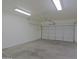 This garage features a garage door, ceiling lights, and concrete floors at 2333 W Alta Vista Rd, Phoenix, AZ 85041