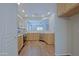 Bright kitchen features wood cabinets, stainless steel appliances and a pass-through window to the living area at 2333 W Alta Vista Rd, Phoenix, AZ 85041
