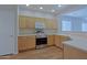 Charming kitchen featuring wood cabinets, stainless steel appliances and laminate flooring at 2333 W Alta Vista Rd, Phoenix, AZ 85041
