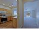 Bright kitchen with wood cabinets, stainless steel appliances and an opening to the carpeted living room at 2333 W Alta Vista Rd, Phoenix, AZ 85041