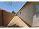 Property side yard with a long area along the building and block wall with blue recycle bin at 2333 W Alta Vista Rd, Phoenix, AZ 85041