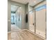 Well-lit bathroom showcases a glass-enclosed shower, wood-look flooring, and a hallway view at 2955 E Lucky Horseshoe Ln, San Tan Valley, AZ 85140