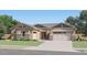 Inviting single-story home with neutral color palette, well-manicured lawn, and a two-car garage at 2955 E Lucky Horseshoe Ln, San Tan Valley, AZ 85140
