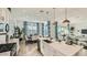 Bright open concept kitchen with an island and stainless appliances, seamlessly flowing into dining and living areas at 2955 E Lucky Horseshoe Ln, San Tan Valley, AZ 85140