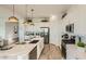 A modern kitchen with stainless steel appliances, a center island, and ample cabinet space for storage and organization at 2955 E Lucky Horseshoe Ln, San Tan Valley, AZ 85140