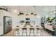 Bright kitchen featuring a large center island with seating, modern appliances, and a dining area at 2955 E Lucky Horseshoe Ln, San Tan Valley, AZ 85140
