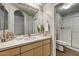 Bright bathroom featuring a modern vanity, quartz countertop and glass enclosed shower at 29606 N Tatum N Blvd # 265, Cave Creek, AZ 85331