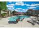 Beautiful community pool surrounded by lush landscaping and comfortable lounge chairs at 29606 N Tatum N Blvd # 265, Cave Creek, AZ 85331
