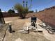 Fenced backyard showing pool equipment on a dry, dirt lot, with potential for landscaping at 324 E Riviera Dr, Tempe, AZ 85282
